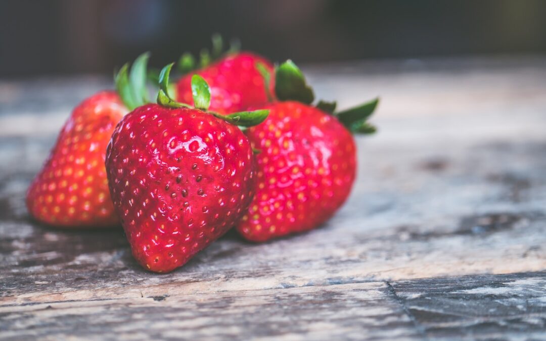 Shallow Focus Photo of Strawberries on Gray Wooden Surface